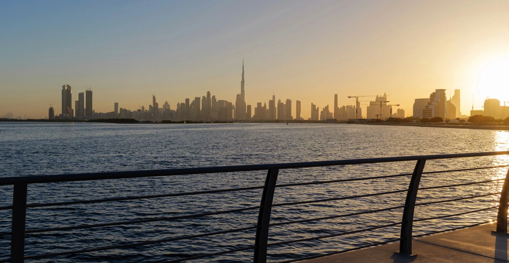 Other UAE Emirates Free Zone skyline silhouette across calm waterfront